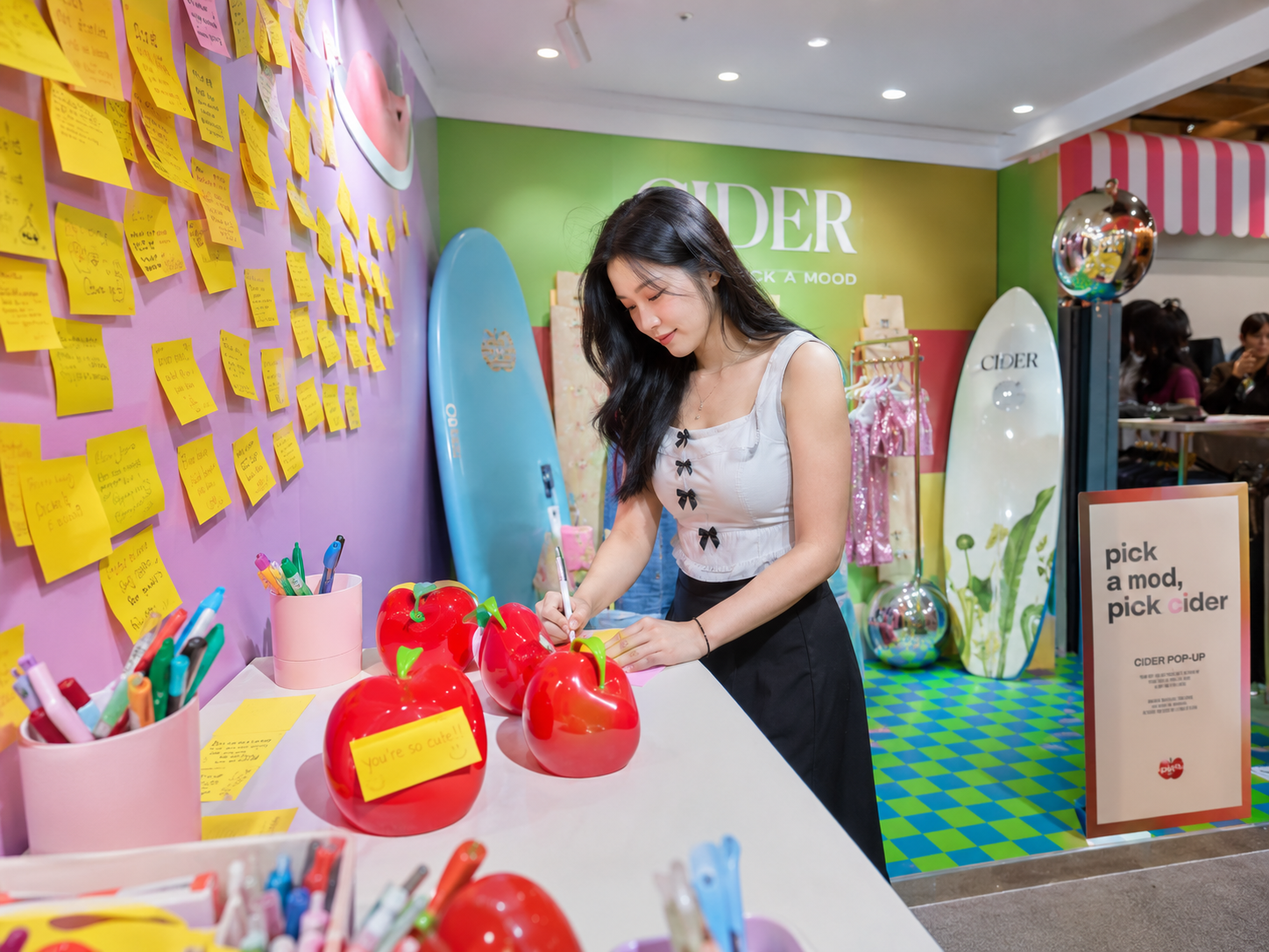 Sticky note wall with apple installations and writing activity